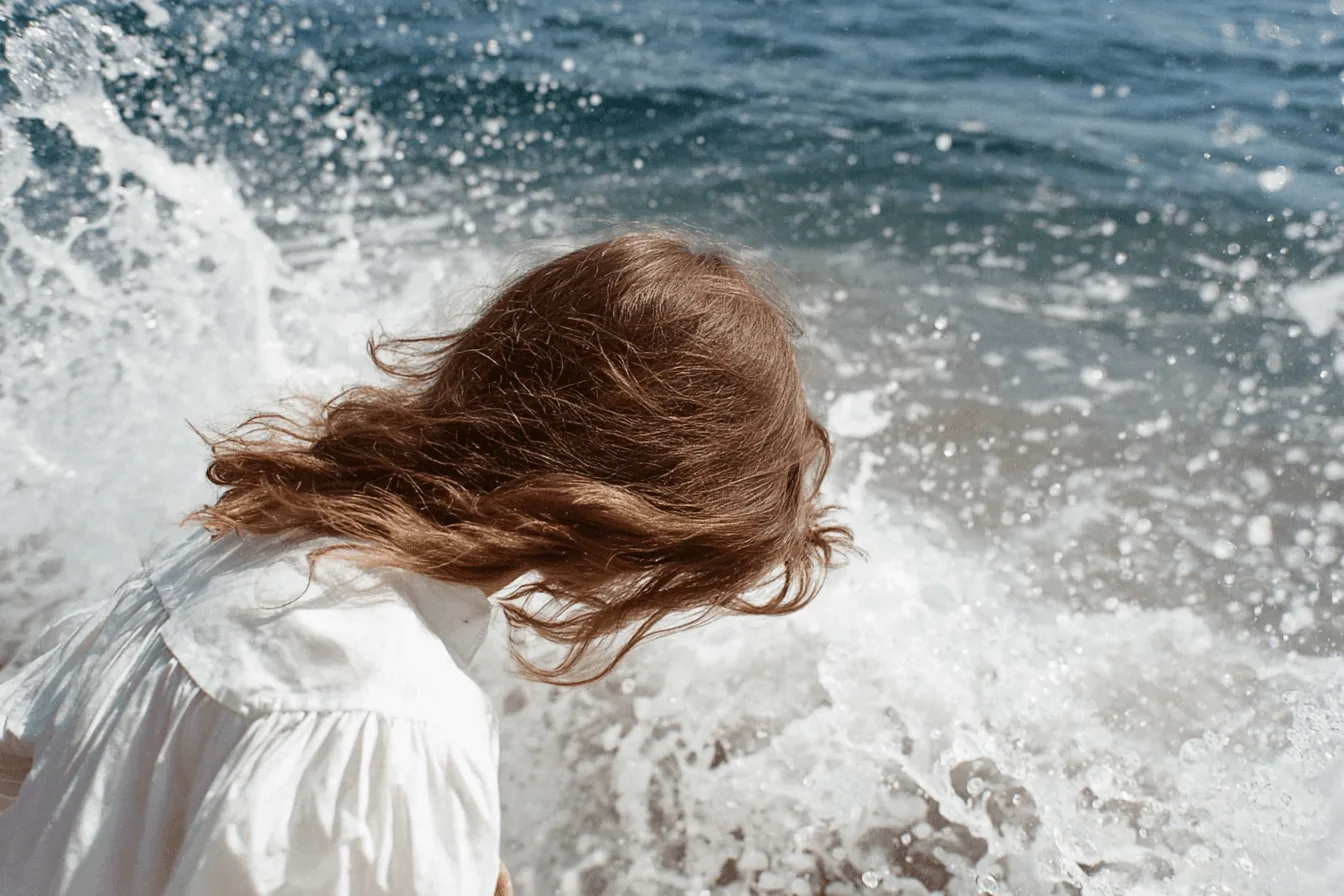 Woman by the sea with waves splashing